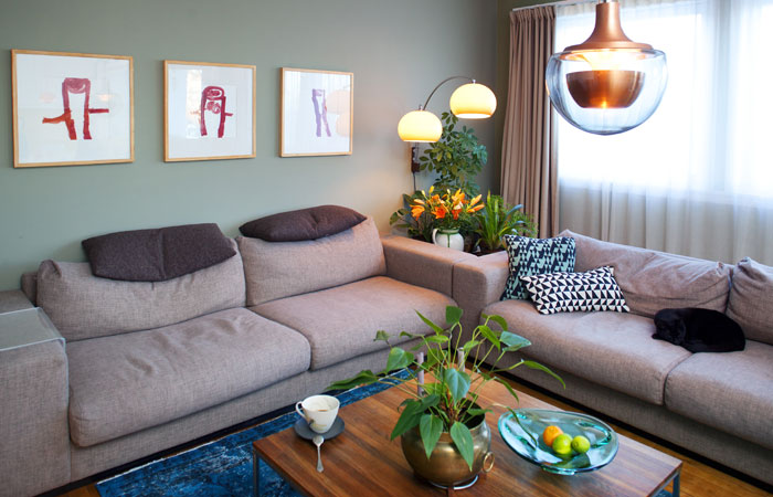 70-TALLET: Hun som har innredet stuen, er glad i 70-tallet. Lampene kommer fra bruktbutikker, den grønne veggen kommer fra Mad Men og Thomas, som nå er ti, har tegnet mor, far og seg selv.
