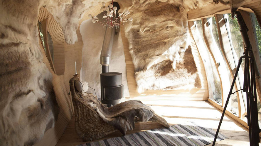 REINSDYR: De 25 reinsdyrskinnene som dekorerer veggene og gir ekstra isolasjon, fikk de fra is-hotellet nord i Sverige der de lærte om samisk kultur. Lampen symboliserer sjelene til reinsdyrene. FOTO: Karen Gjermundrød